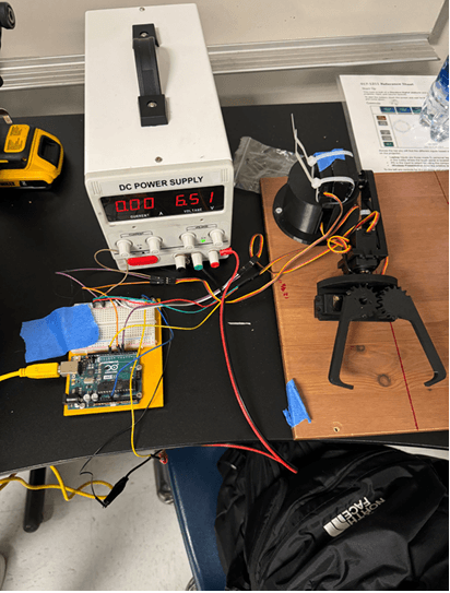 Full Can Arm setup with Arduino, breadboard, and DC power supply